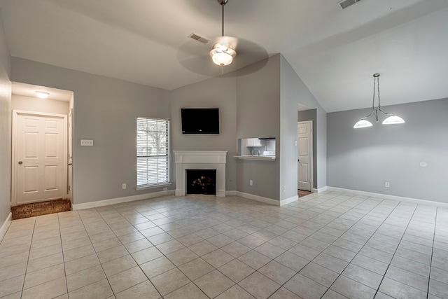 unfurnished living room featuring ceiling fan with notable chandelier, light tile patterned flooring, and lofted ceiling