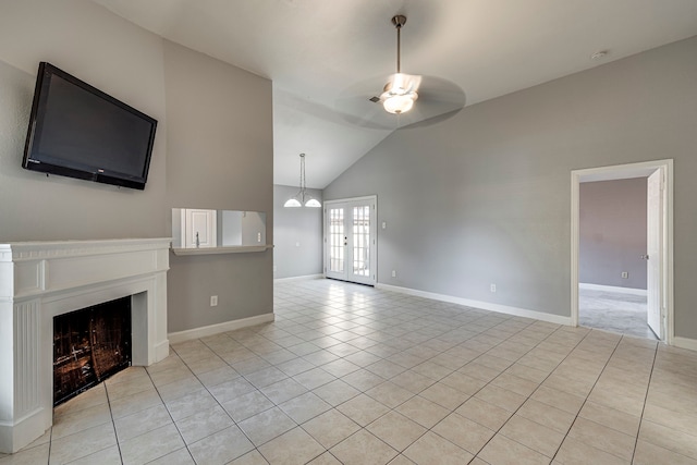 unfurnished living room featuring ceiling fan, lofted ceiling, light tile patterned floors, and french doors