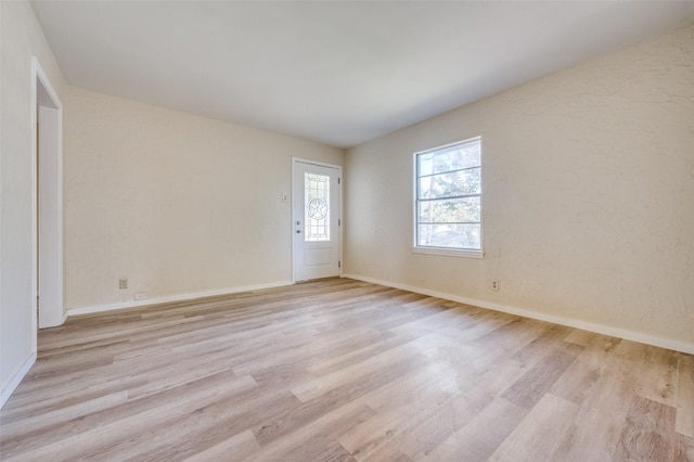 unfurnished room with light wood-type flooring