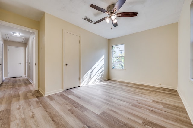 empty room with ceiling fan and light wood-type flooring