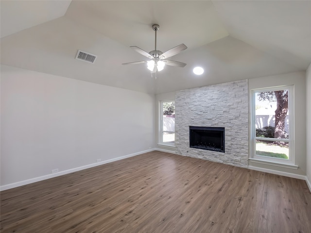 unfurnished living room featuring hardwood / wood-style flooring, ceiling fan, a fireplace, and vaulted ceiling