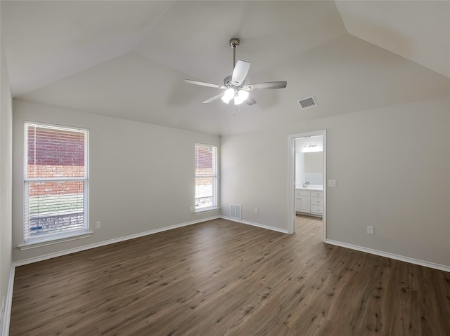 unfurnished room featuring vaulted ceiling, ceiling fan, and dark hardwood / wood-style floors