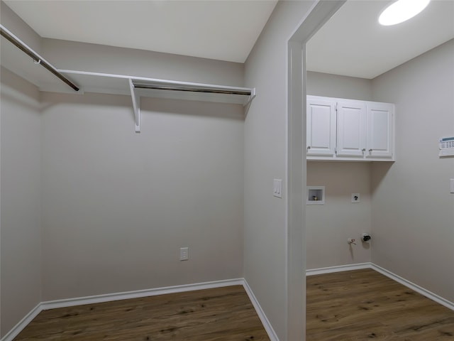 washroom featuring cabinets, hookup for a washing machine, electric dryer hookup, dark hardwood / wood-style floors, and hookup for a gas dryer