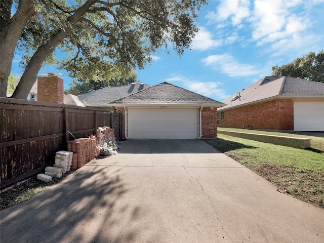 view of side of home with a yard and a garage