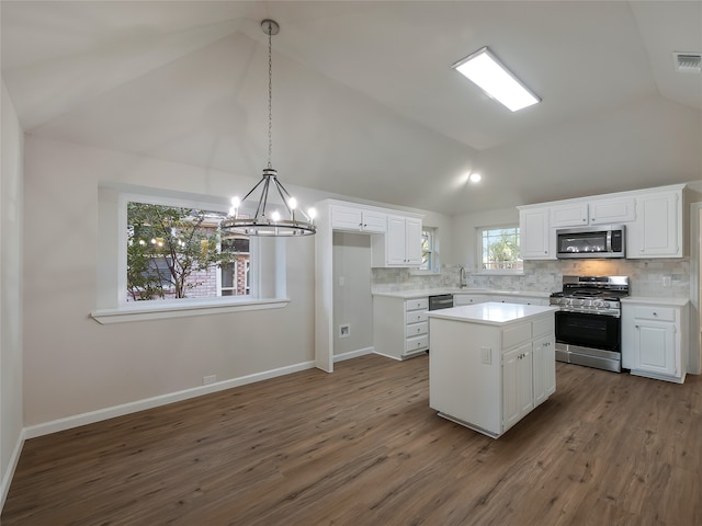 kitchen featuring a center island, white cabinetry, dark wood-type flooring, and appliances with stainless steel finishes