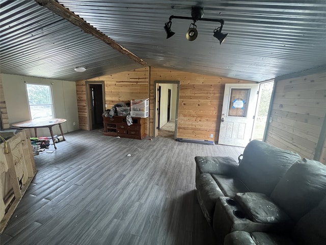 living room featuring lofted ceiling, wood-type flooring, and wooden walls