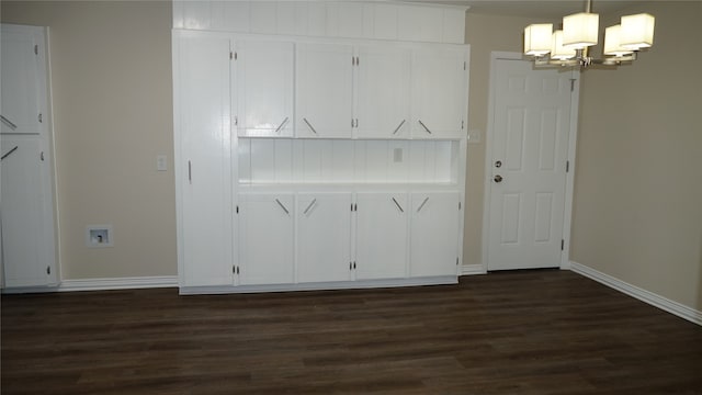 kitchen featuring white cabinets, dark hardwood / wood-style floors, hanging light fixtures, and a chandelier