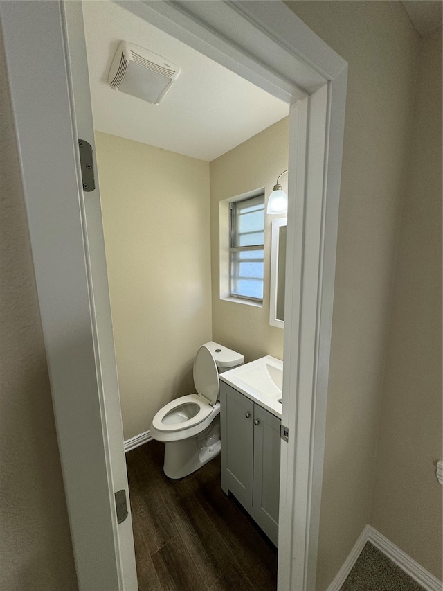 bathroom featuring hardwood / wood-style floors, vanity, and toilet