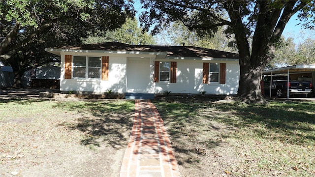 single story home featuring a front lawn and a carport