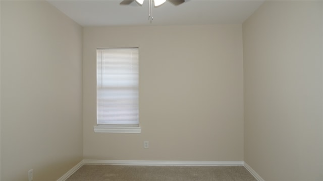 carpeted spare room with ceiling fan