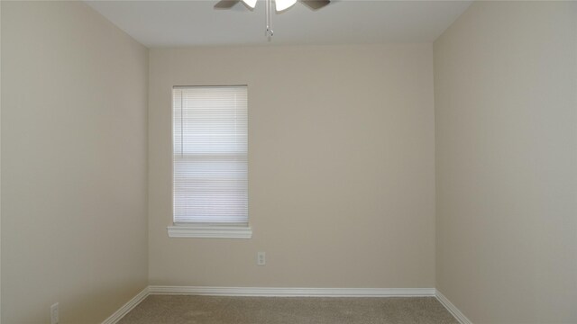 carpeted spare room with ceiling fan