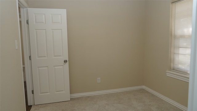 unfurnished room with light carpet