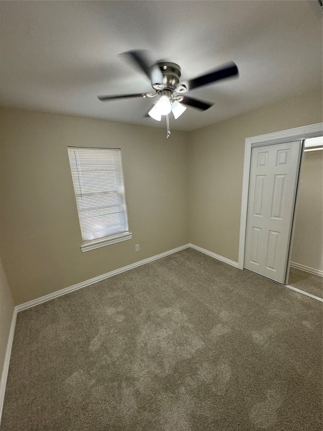 unfurnished bedroom with carpet, a closet, and ceiling fan