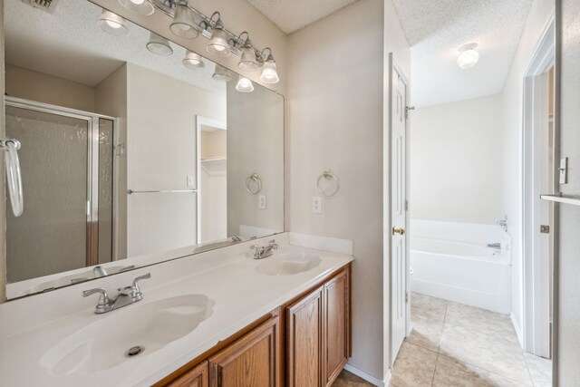 bathroom featuring shower with separate bathtub, a textured ceiling, and tile patterned floors