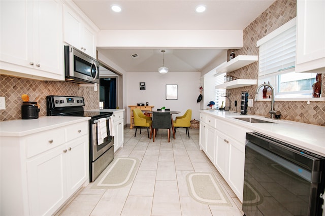 kitchen featuring decorative light fixtures, backsplash, stainless steel appliances, and white cabinetry