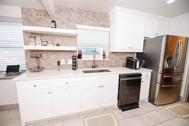 kitchen with beam ceiling, white cabinetry, sink, black dishwasher, and stainless steel fridge