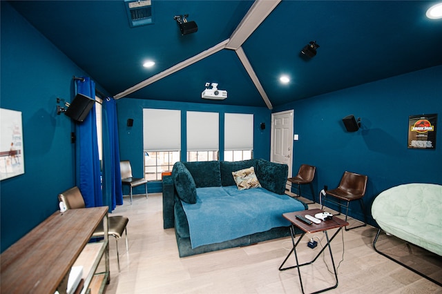 bedroom featuring light hardwood / wood-style flooring and lofted ceiling with beams