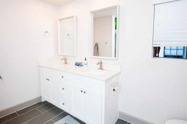 bathroom featuring tile patterned flooring and vanity