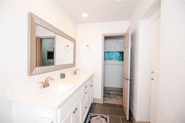 bathroom featuring tile patterned flooring and vanity