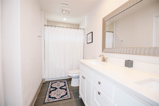 bathroom featuring tile patterned flooring, vanity, toilet, and curtained shower