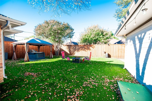 view of yard featuring a gazebo and a hot tub