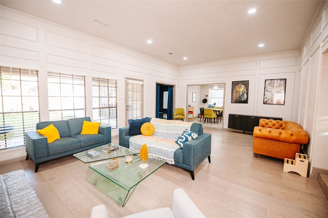 living room with light hardwood / wood-style floors and plenty of natural light