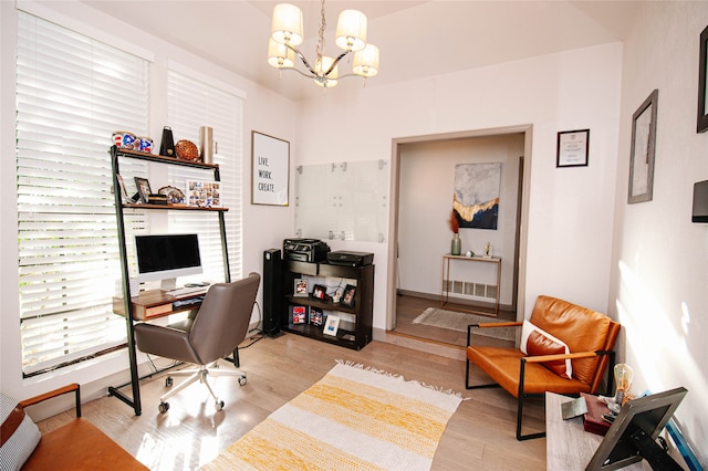 home office featuring light hardwood / wood-style flooring and an inviting chandelier