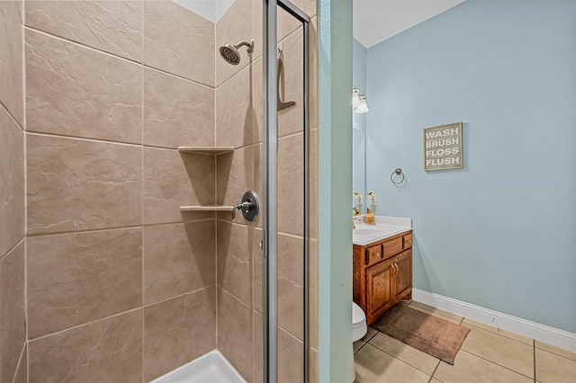 full bath featuring toilet, a shower stall, vanity, tile patterned flooring, and baseboards