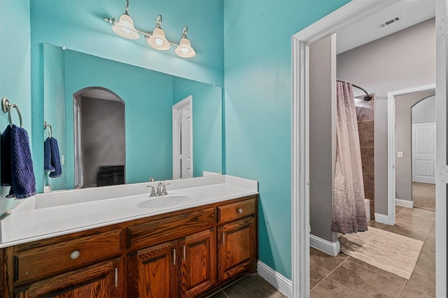 bathroom with tile patterned flooring, visible vents, vanity, and baseboards