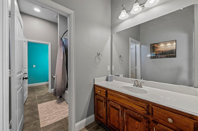 full bath with shower / tub combo, tile patterned floors, baseboards, and vanity