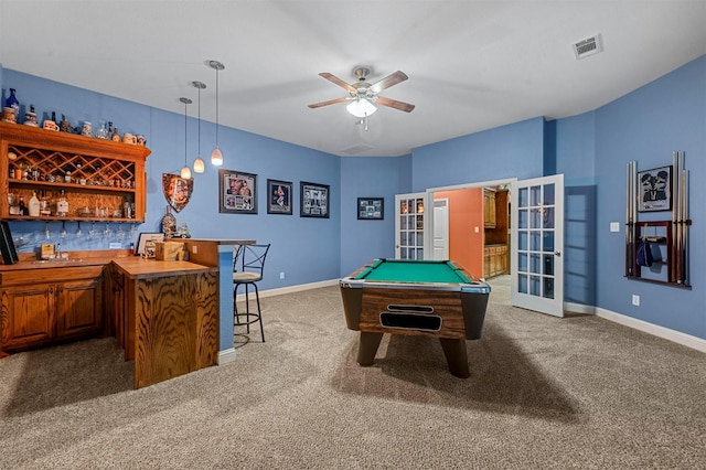 game room featuring baseboards, visible vents, french doors, a bar, and dark carpet