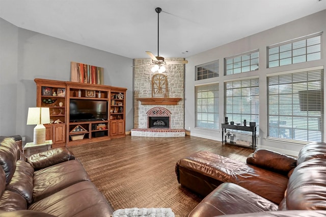 living area with dark wood-style floors, a fireplace, and baseboards