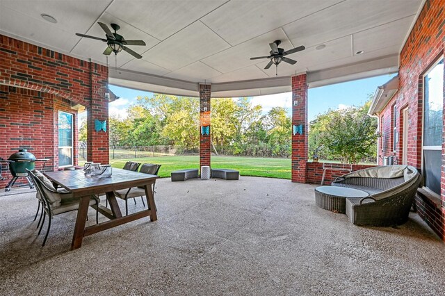 view of patio with outdoor dining area, ceiling fan, area for grilling, and fence