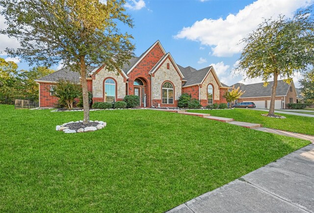 view of front of home with brick siding and a front yard