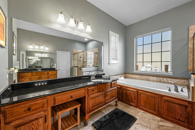 full bathroom with a stall shower, a garden tub, and vanity