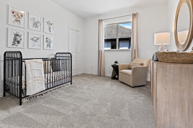 carpeted bedroom with a nursery area