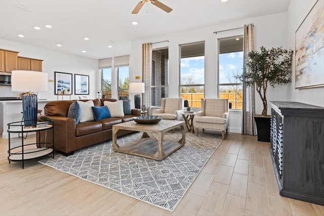 living room featuring light hardwood / wood-style flooring and ceiling fan