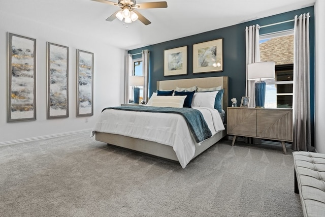 bedroom featuring multiple windows, ceiling fan, and carpet