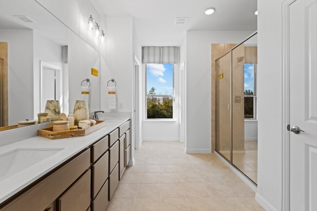 bathroom featuring tile patterned floors, vanity, and an enclosed shower