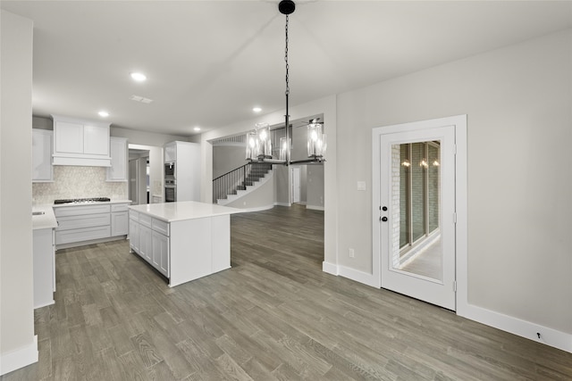 724 Stearman Ln, Fate, TX 75087 - kitchen with gas stovetop, light countertops, white cabinets, stainless steel microwave, and recessed lighting
