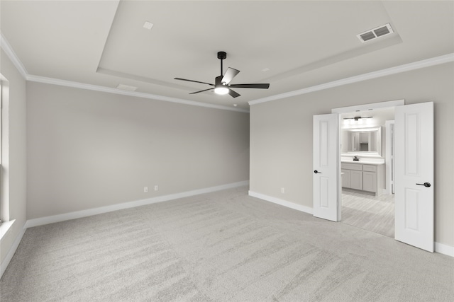 empty room featuring ceiling fan, light colored carpet, and crown molding