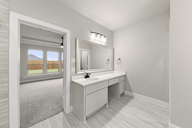 bathroom with vanity, hardwood / wood-style flooring, and ceiling fan