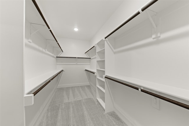 spacious closet featuring light carpet