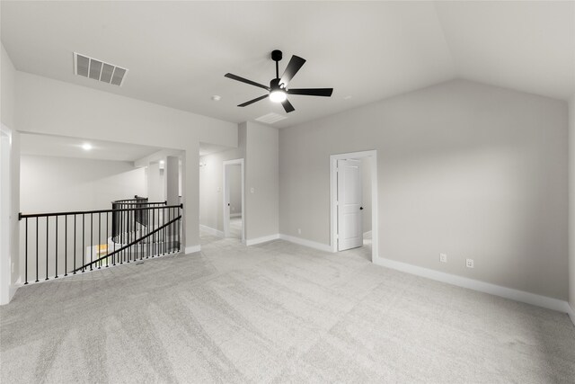 empty room with light carpet, ceiling fan, and lofted ceiling