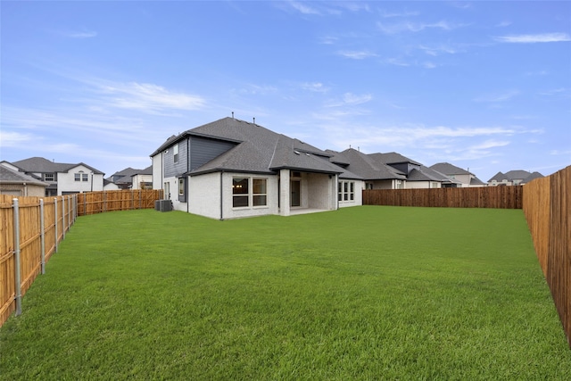 rear view of house featuring a yard