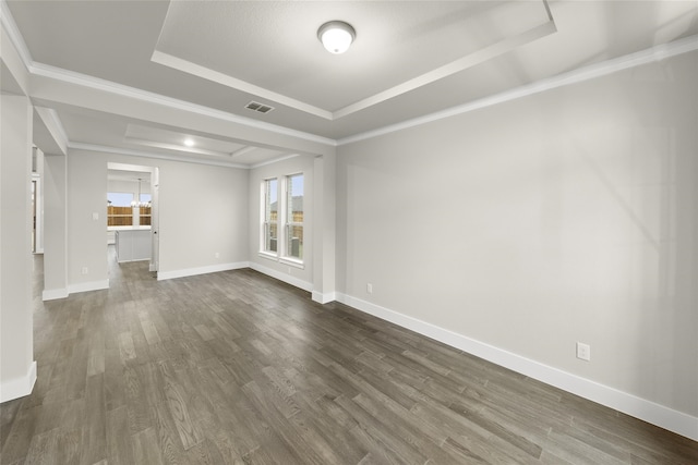 unfurnished room with dark hardwood / wood-style floors, crown molding, and a tray ceiling