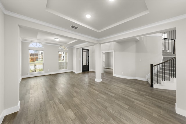 724 Stearman Ln, Fate, TX 75087 - unfurnished living room featuring a raised ceiling, stairs, wood finished floors, and ornamental molding