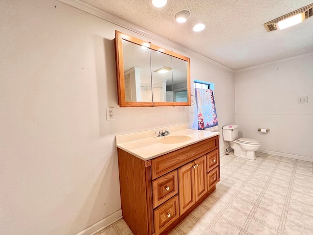 bathroom with vanity, a textured ceiling, and toilet