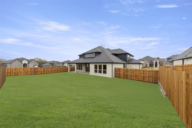 back of house featuring a yard