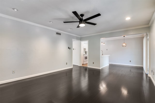 empty room featuring ceiling fan, dark hardwood / wood-style flooring, and ornamental molding